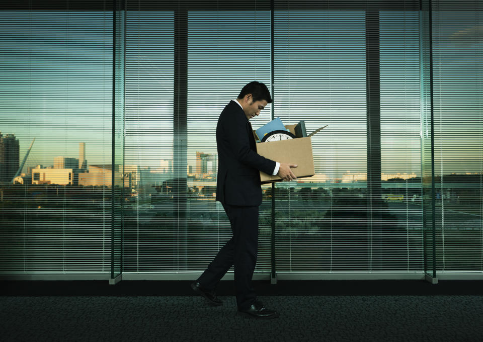 Subject: A Japanese business office worker leaving his job with all his belonging in a layoff and economic recession.