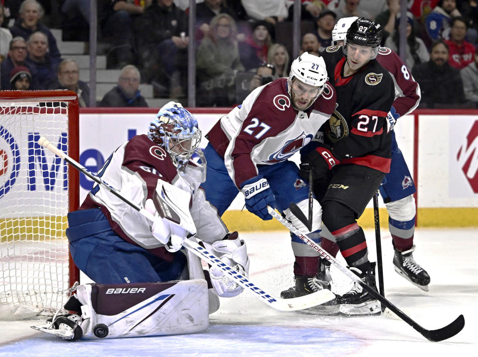 Colorado Avalanche left wing Jonathan Drouin (27) and Ottawa Senators left wing Parker Kelly (27) watch the puck rebound past the pad of Avalanche goaltender Justus Annunen (60) during the second period of an NHL hockey game, Tuesday, Jan. 16, 2024 in Ottawa, Ontario. (Justin Tang/The Canadian Press via AP)