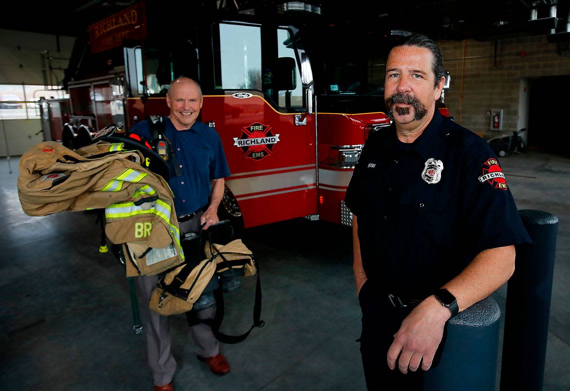 In a reversal of roles from eight years ago, retired Richland fire chief Grant Baynes, left, will follow Richland Fire Capt. Damon Bryan, down the the stairs carrying his heavy protective fire gear after both of them complete Sunday’s stair climb competition in Seattle. Bryan is retiring this year after nearly 28 years of fire service with the Richland Fire Department.