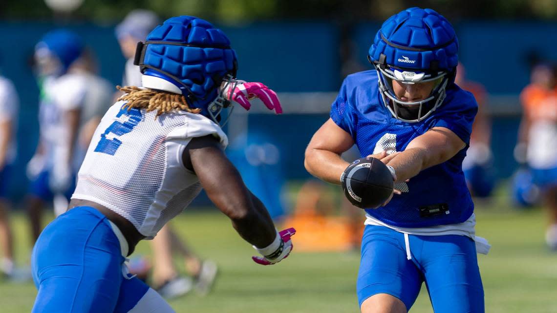 Quarterback Maddux Madsen hands off the ball to running back Ashton Jeanty during football practice at Boise State University, Thursday, Aug. 1, 2024.