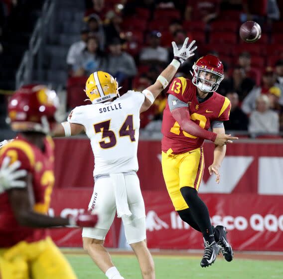 LOS ANGELES, CALIF. - OCT. 1, 2022. USC quarterback Caleb Williams throws on the run against Arizona State.