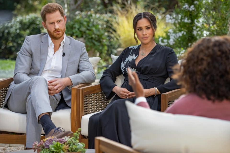This image provided by Harpo Productions shows Prince Harry, from left, and Meghan, Duchess of Sussex, during an interview with Oprah Winfrey (AP)