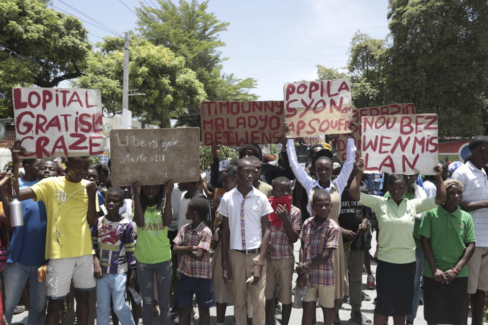 Students from the El Roi academy carry signs during a demonstration to demand the freedom of New Hampshire nurse Alix Dorsainvil and her daughter, who have been reported kidnapped, in the Cite Soleil neighborhood of Port-au-Prince, Haiti, Monday, July 31, 2023. Dorsainvil works for the El Roi Haiti nonprofit organization and the U.S. State Department issued a "do not travel advisory" ordering nonemergency personnel to leave the Caribbean nation amid growing security concerns. (AP Photo/Odelyn Joseph)