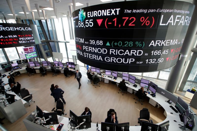 FILE PHOTO: Stock market operators work at the Euronext headquarters at La Defense business and financial district in Courbevoie near Paris