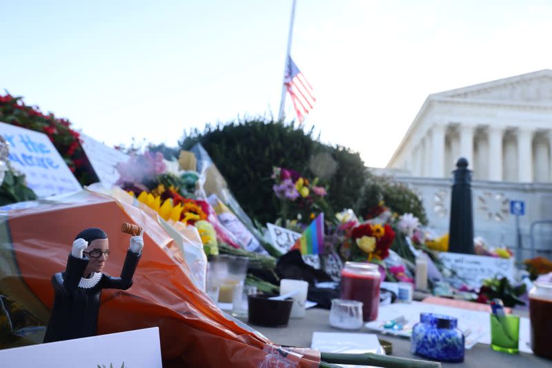 Flowers and tributes are seen as people gather in front of the U.S. Supreme Court following the death of U.S. Supreme Court Justice Ruth Bader Ginsburg, in Washington