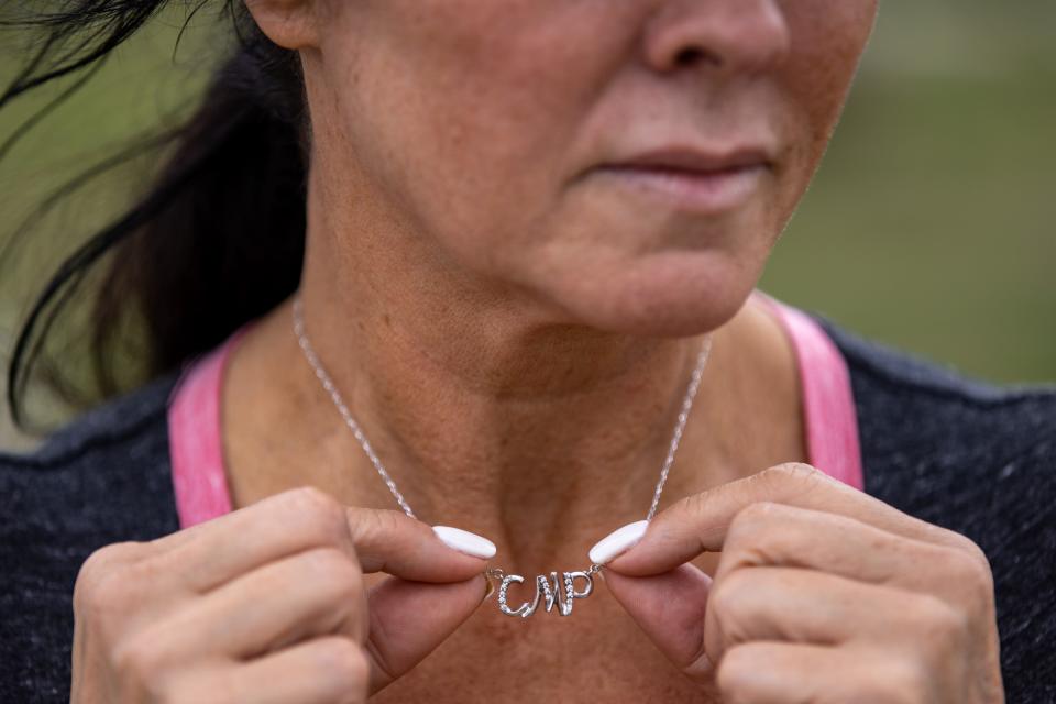 Rhonda Packineau wears a necklace with the initials of her daughter's name, Cheyenne Marie Packineau.