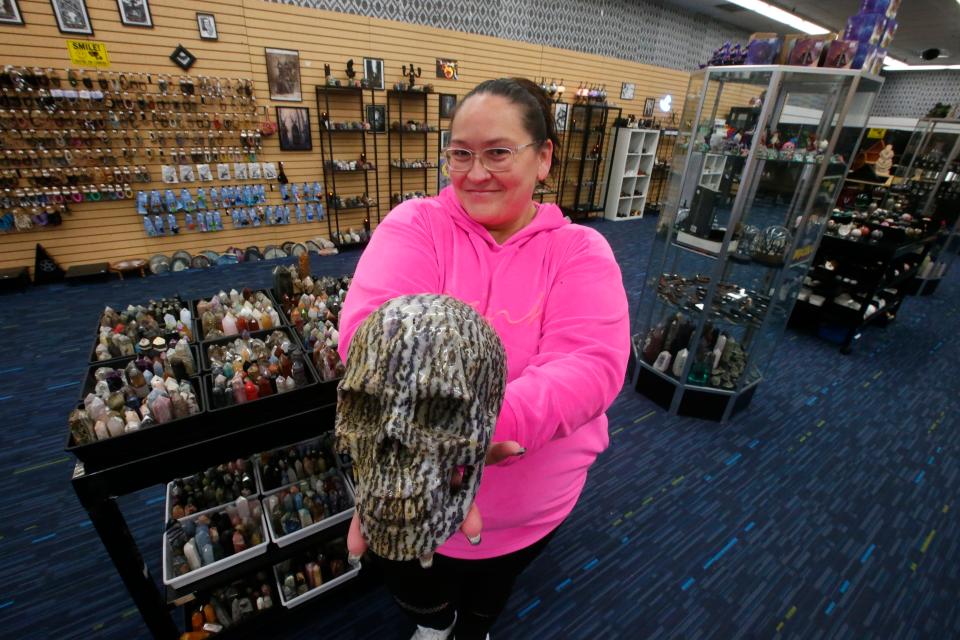 Florrie Steele holds a a stone skull at Midnight, Moonlight and Magick at the Dartmouth Mall.