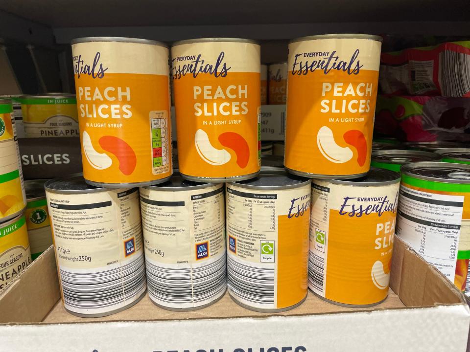 Canned peach slices stacked on top of each other at Aldi