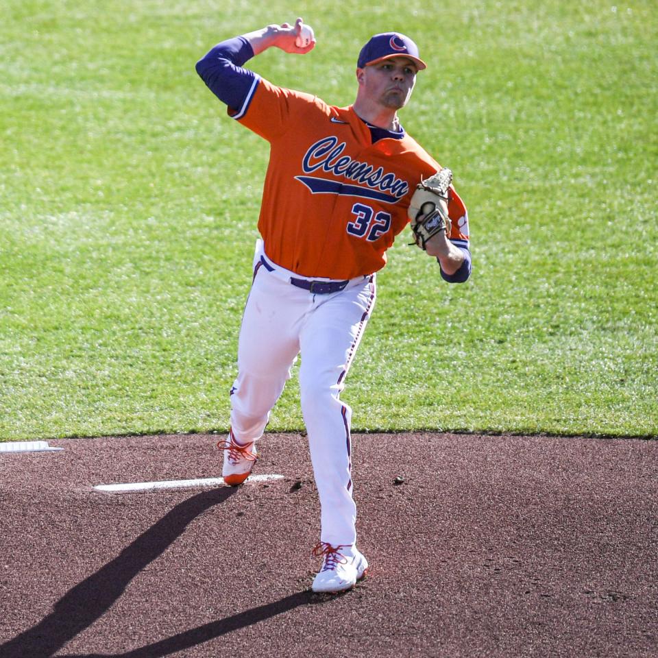 Clemson sophomore Mack Anglin (32) throws the first pitch against Indiana during the top of the first inning at Doug Kingsmore Stadium in Clemson Friday, February 18, 2022.