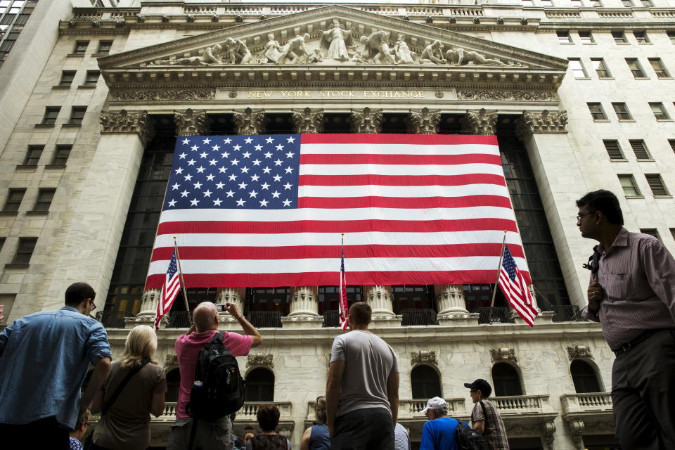 A large U.S. flag hangs on the facade of the New York Stock Exchange in New York September 3, 2015.  REUTERS/Lucas Jackson 