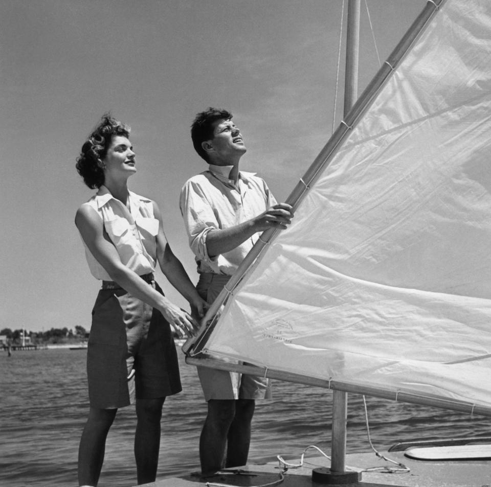 <p>Senator John F. Kennedy of Massachusetts is shown with his fiancee, Jacqueline Bouvier, as the couple adjusts the rigging on a boat during a vacation at the Kennedy compound in Hyannis Port, Massachusetts.</p>