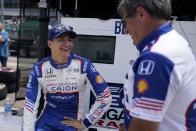 Alex Palou, of Spain, talks with a crew member before practice for the Indianapolis 500 auto race at Indianapolis Motor Speedway, Monday, May 22, 2023, in Indianapolis. (AP Photo/Darron Cummings)