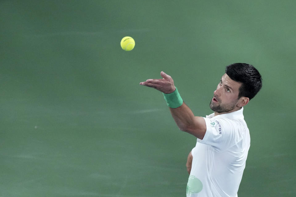 Serbia's Novak Djokovic serves to Czech Republic's Jiri Vesely during a match at the Dubai Duty Free Tennis Championship in Dubai, United Arab Emirates, Thursday, Feb. 24, 2022. (AP Photo/Ebrahim Noroozi)