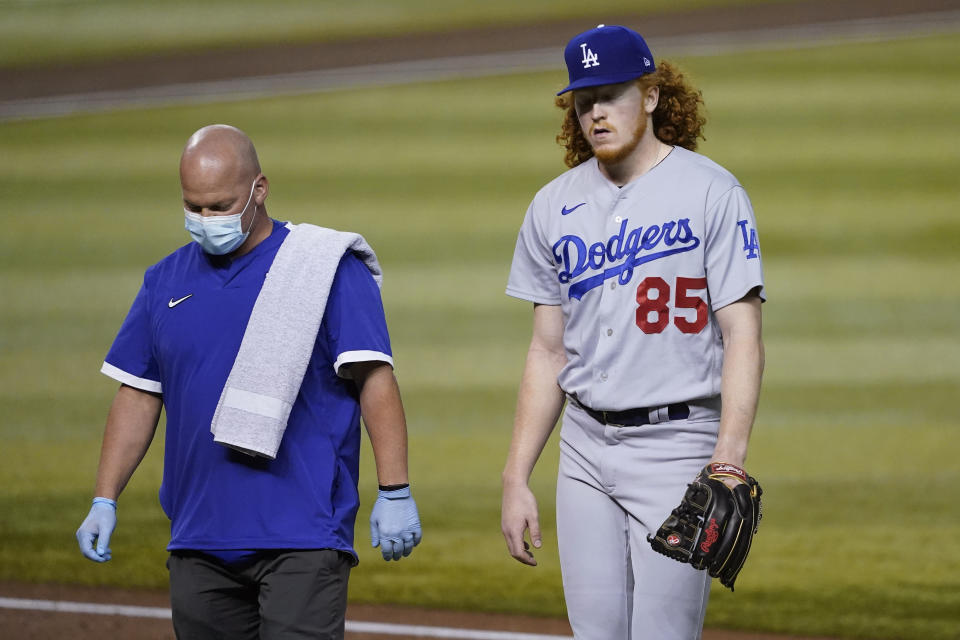 Los Angeles Dodgers starting pitcher Dustin May (85) is pulled from the baseball game during the second inning against the Arizona Diamondbacks, Thursday, Sept. 10, 2020, in Phoenix. May took a line drive off his foot in the first inning and was unable to continue. (AP Photo/Matt York)