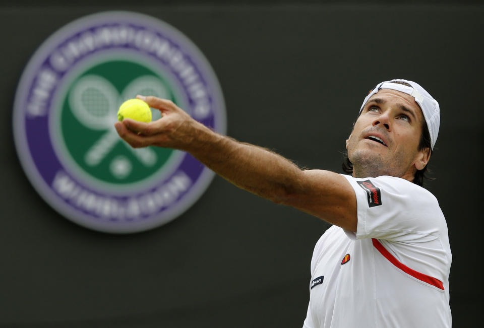 Tommy Haas of Germany serves during his match against Milos Raonic of Canada at the Wimbledon Tennis Championships in London, July 1, 2015. REUTERS/Suzanne Plunkett