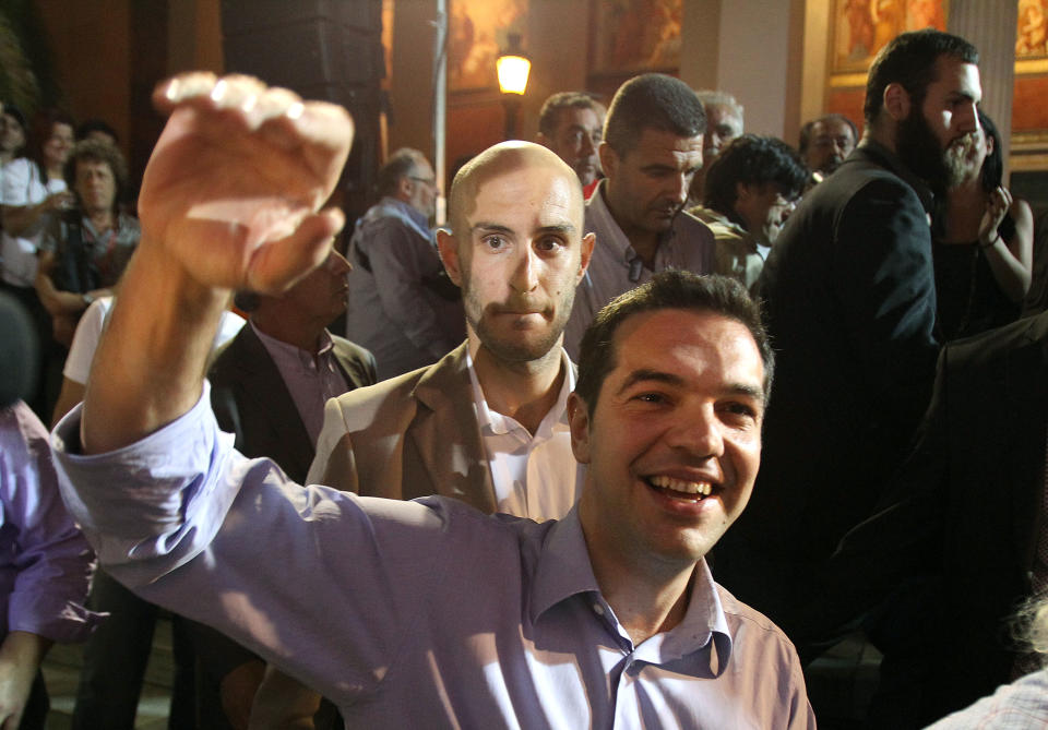 Head of Greece's radical left-wing Syriza party Alexis Tsipras waves to his supporters in Athens, late Sunday, June 17, 2012. Alexis Tsipras and his party shot to prominence in the May 6 vote, where he came a surprise second and quadrupled his support since the 2009 election. Syriza party has vowed to rip up Greece's bailout agreements and repeal the austerity measures, which have included deep spending cuts on everything from health care to education and infrastructure, as well as tax hikes and reductions of salaries and pensions. (AP Photo/Petros Karadjias)