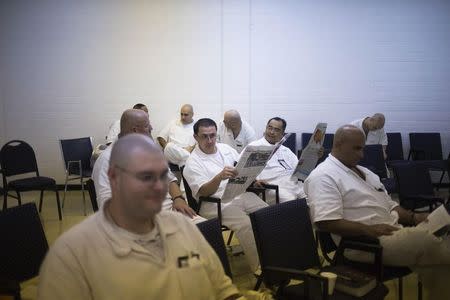 Offenders read inside the Southwestern Baptist Theological Seminary located in the Darrington Unit of the Texas Department of Criminal Justice men's prison in Rosharon, Texas August 12, 2014. REUTERS/Adrees Latif