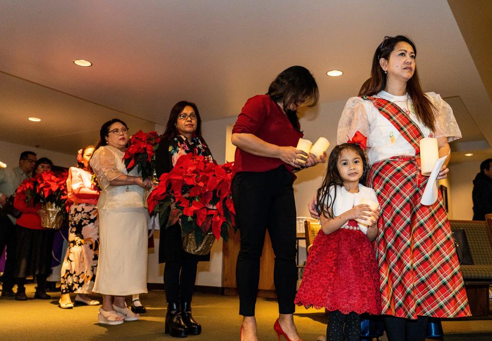 Abby Mira of Franklin and her 4-year-old daughter Kaira Mira prepare to lead the procession of the second of nine Masses for Simbang Gabi on Saturday December 16, at St. Alphonsus Parish 2023 in Greendale, Wis. 



Jovanny Hernandez / Milwaukee Journal Sentinel