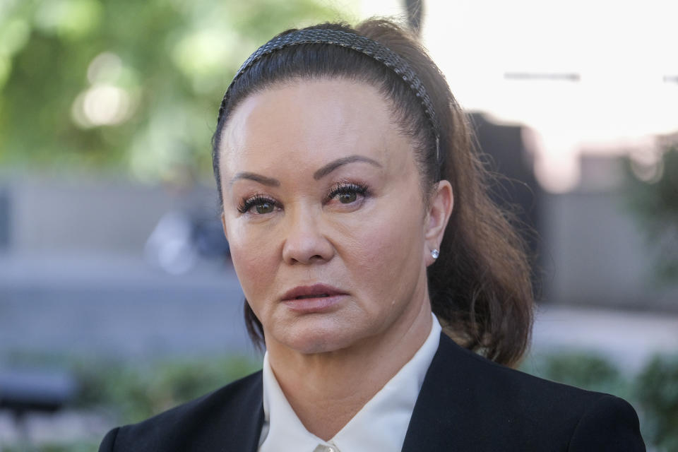 Alana Gee, the widow of a former University of Southern California football player suing the NCAA for failing to protect her husband from repetitive head trauma, leaves the Stanley Mosk civil courthouse of Los Angeles Superior Court on Friday, Oct. 21, 2022. Matthew Gee died in 2018 from permanent brain damage caused by countless blows to the head he took while playing linebacker for the 1990 Rose Bowl winning team, according to the wrongful death suit filed by Alana Gee. (AP Photo/Ringo H.W. Chiu)