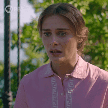 A woman in a pink blouse with light embroidery, with a concerned expression, outdoor greenery in the background. PBS logo is at the top left