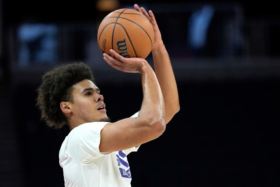 Phoenix Suns forward Cameron Johnson warms up for the team's NBA basketball game against the Minnesota Timberwolves, Friday, Jan. 13, 2023, in Minneapolis. (AP Photo/Abbie Parr)