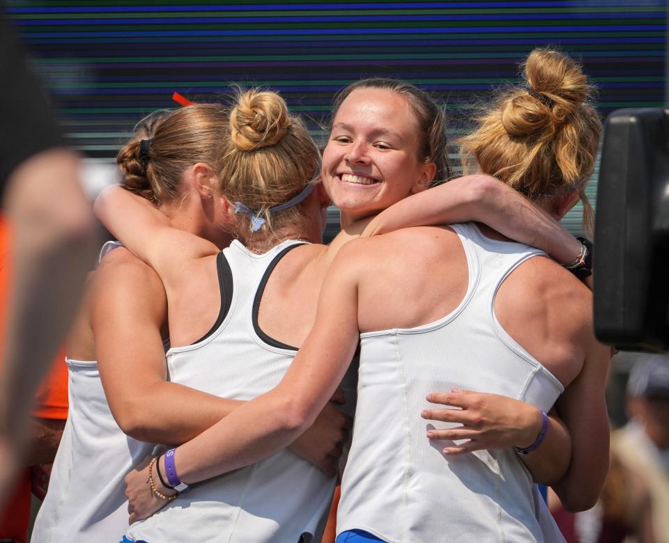 Members of the Van Meter girls distance medley celebrate a Class 2A state title during the Iowa High School state track and field championships at Drake Stadium in Des Moines on Friday, May 19, 2023.