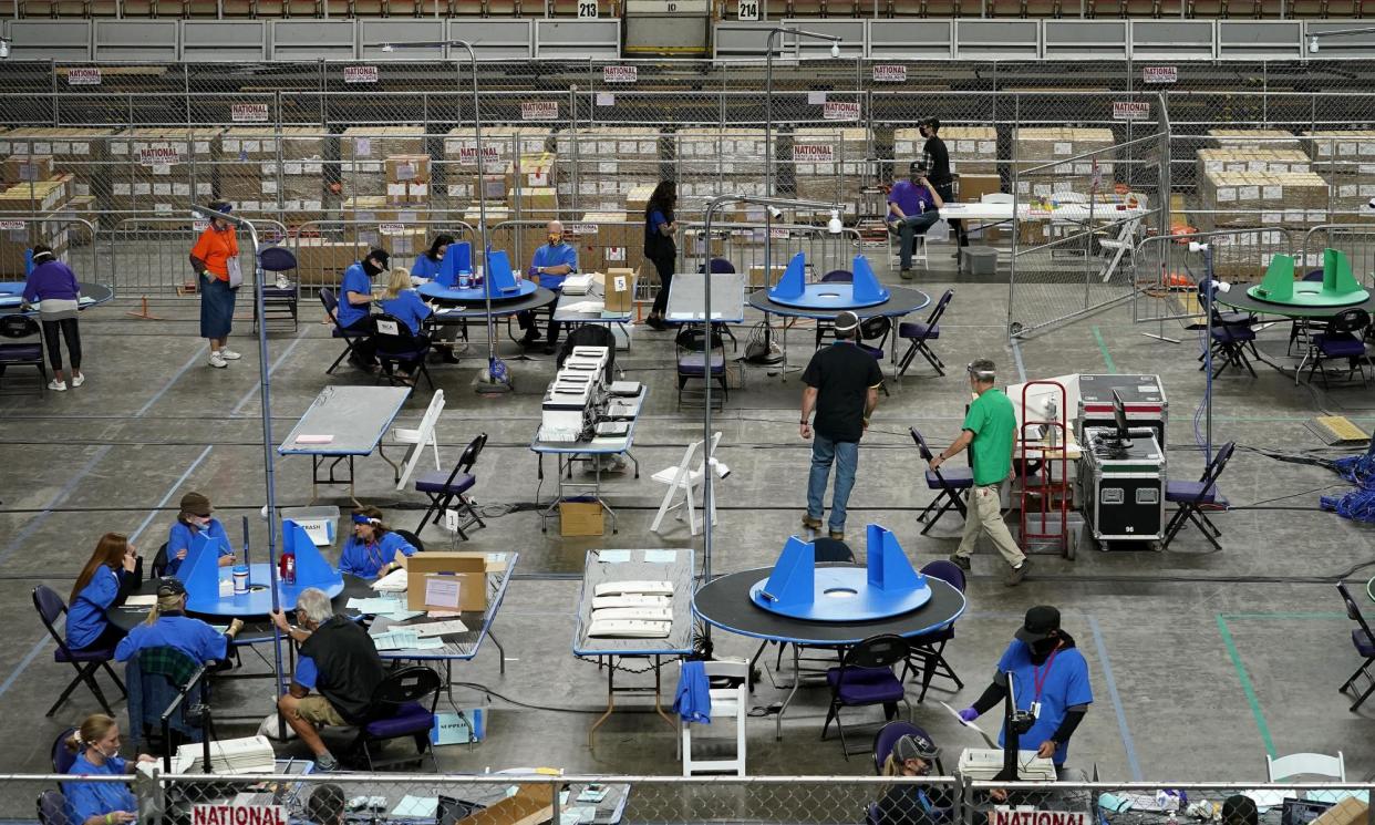 <span>Maricopa county ballots cast in the 2020 general election are examined and recounted by contractors working for Florida-based company, Cyber Ninjas, in Phoenix on 6 May 2021.</span><span>Photograph: Matt York/AP</span>