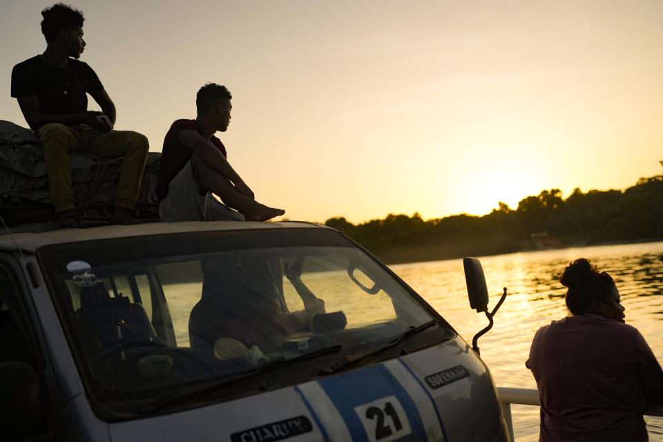 FILE - Travelers look out at the Essequibo River as they ride a ferry carrying vehicles across Guyana's Kurupukari crossing, April 10, 2023. Venezuela has long claimed Guyana’s Essequibo region — a territory larger than Greece and rich in oil and minerals.(AP Photo/Matias Delacroix, File)