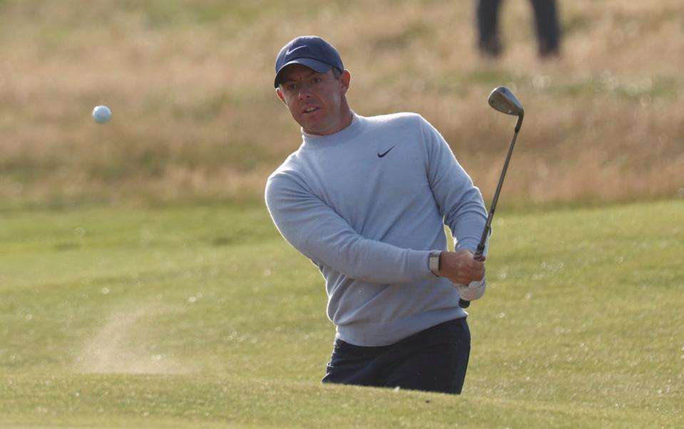 Northern Ireland's Rory McIlroy played out of a bunker on the 15th hole on the first day of the British Open Golf Championships at the Royal Liverpool Golf Club in Hoylake, England