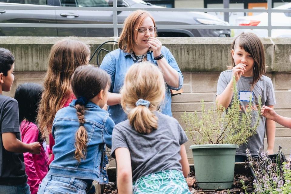 Children plant seeds at garden club at the Monroe County Public Library's downtown location.