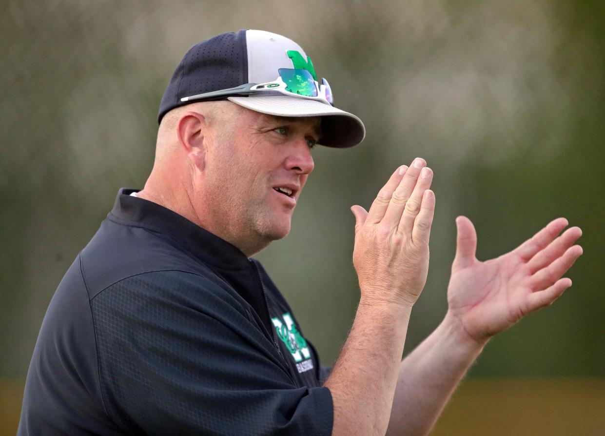 Mogadore baseball coach Chris Williams works the third base line during the seventh inning of a high school baseball game against Garfield, Wednesday, May 1, 2024, in Garrettsville, Ohio.