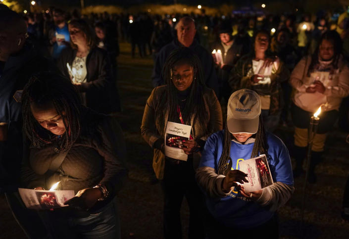 Community members, including Walmart employees, gather for a candlelight vigil at Chesapeake City Park in Chesapeake, Va., Monday, Nov. 28, 2022, for the six people killed at a Walmart in Chesapeake, Va., when a manager opened fire with a handgun before an employee meeting last week. (AP Photo/Carolyn Kaster)