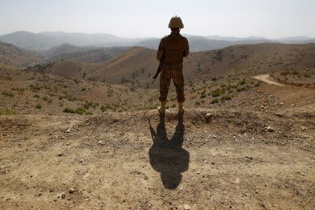 A soldier stands guard outside the Kitton outpost along the border fence on the border with Afghanistan in North Waziristan, Pakistan October 18, 2017. REUTERS/Caren Firouz