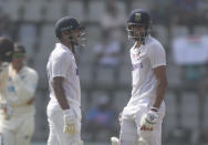 India's Mayank Agarwal , left, talks with Axar Patel during the day two of their second test cricket match with New Zealand in Mumbai, India, Saturday, Dec. 4, 2021.(AP Photo/Rafiq Maqbool)