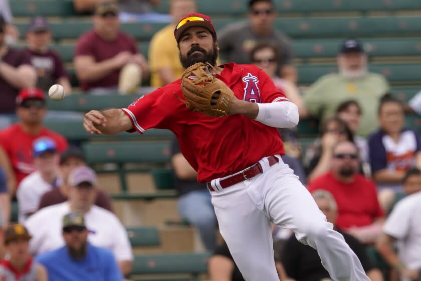 Los Angeles Angels' Anthony Rendon fields a base hit by Oakland Athletics' Kevin Smith.