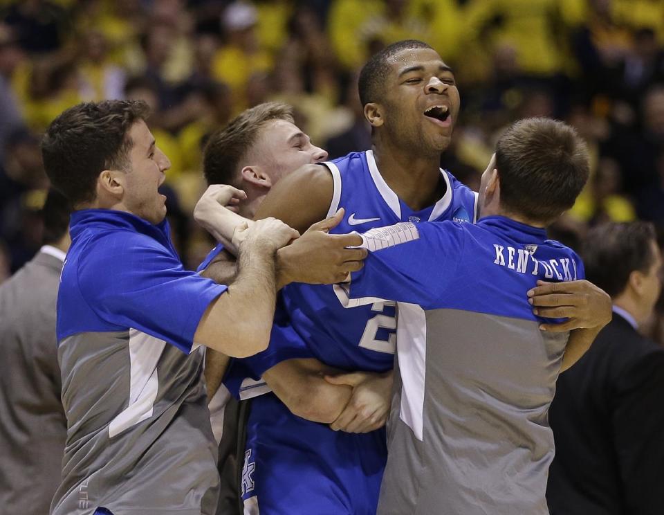 Kentucky's Aaron Harrison celebrates with his teammates after an NCAA Midwest Regional final college basketball tournament game against Michigan Sunday, March 30, 2014, in Indianapolis. Kentucky won 75-72 to advance to the Final Four. (AP Photo/David J. Phillip)