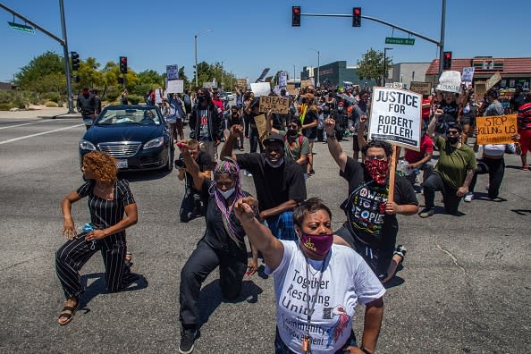 Protesters kneel down during a demonstration on to demand a full investigation into the death of Robert Fuller, a 24-year-old black man found hanging from a tree, in Palmdale, California.