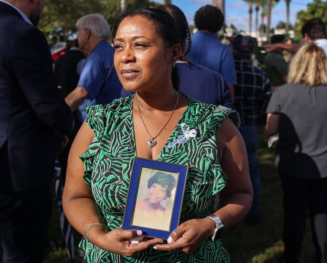 Nichole Shackelford holds a photo of her mother Patricia Renee Shackelford, who died on Flight 401 when she was three years old, as she attended the memorial dedication.