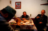 Dusko Mladic (C), first cousin of Ratko Mladic, drinks with his brother and a friend at a makeshift tavern in the village where the former Bosnian Serb military commander Ratko Mladic was born, Bozanovici, Bosnia and Herzegovina, November 8, 2017. REUTERS/Dado Ruvic