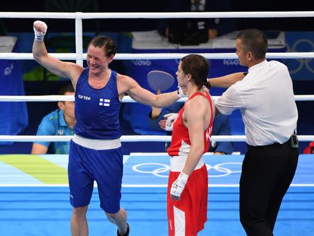 Aug 15, 2016; Rio de Janeiro, Brazil; Mira Potkonen (FIN, blue) reacts as she is named winner of a womenâ€™s light quarterfinal bout against Katie Taylor (IRL, red) at Riocentro - Pavilion 6 during the Rio 2016 Summer Olympic Games. Mandatory Credit: John David Mercer-USA TODAY Sports