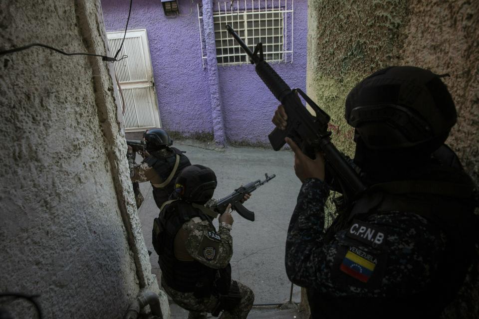 Members the National Police Action Force, or FAES, an elite commando unit created for anti-gang operations, patrol the Antimano neighborhood of Caracas, Venezuela, Tuesday, Jan. 29, 2019. Rights groups say the unit is now acting against disaffected youths living in the slums. (AP Photo/Rodrigo Abd)