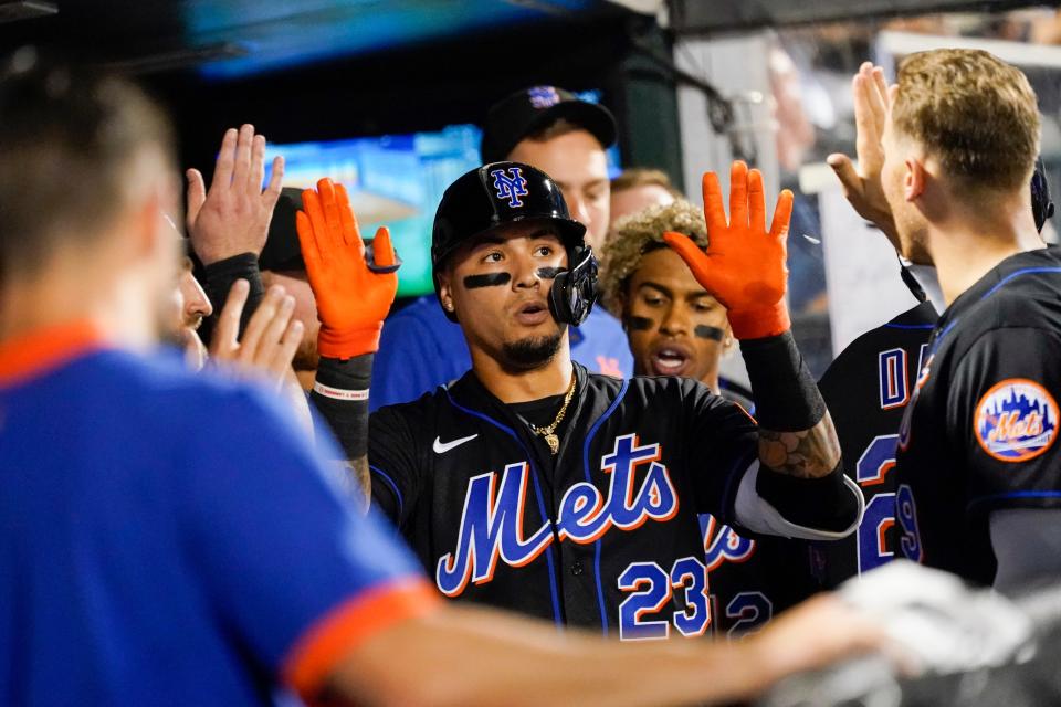 New York Mets' Javier Baez celebrates with his teammates after hitting a solo home run during the fourth inning of a baseball game against the Washington Nationals, Friday, Aug. 27, 2021, in New York. (AP Photo/Mary Altaffer)