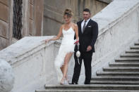 United States' Brooks Koepka and his wife Jena walk down the Spanish Steps as members of the European and the United States Ryder Cup teams pose for the cameras in Rome, Italy, Wednesday, Sept. 27, 2023. The Ryder Cup starts Sept. 29, at the Marco Simone Golf Club. (AP Photo/Gregorio Borgia )