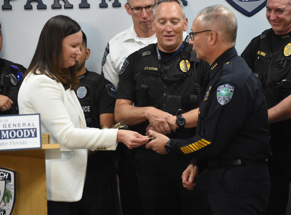 Attorney General Ashley Moody (left) presents her Thin Line Tribute Award to Vero Beach Police Chief David Currey during a ceremony honoring law enforcement on Thursday, April 21, 2022, at the police office in Vero Beach. The Thine Line Tribute highlights the courageous work of law enforcement and their efforts to forge positive relationships with community members.
