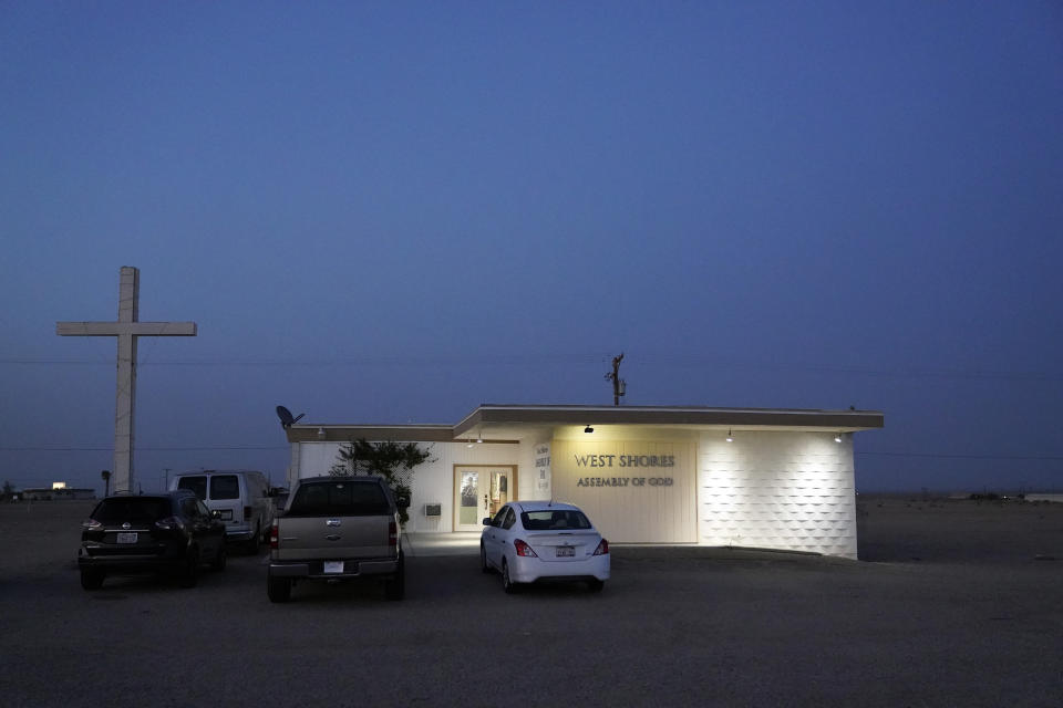 The West Shores Assembly of God building is lit up at dusk Wednesday, July 14, 2021, in Salton City, Calif. The community on the shore of the Salton Sea, California's largest but rapidly shrinking lake, has been through decades of economic stagnation. Now, it's at the forefront of efforts to make the U.S. a major global producer of lithium, the ultralight metal used in rechargeable batteries. (AP Photo/Marcio Jose Sanchez)