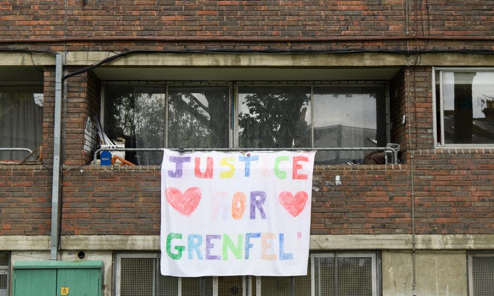 A banner reading ‘Justice for Grenfell’ hangs from a block of flats.