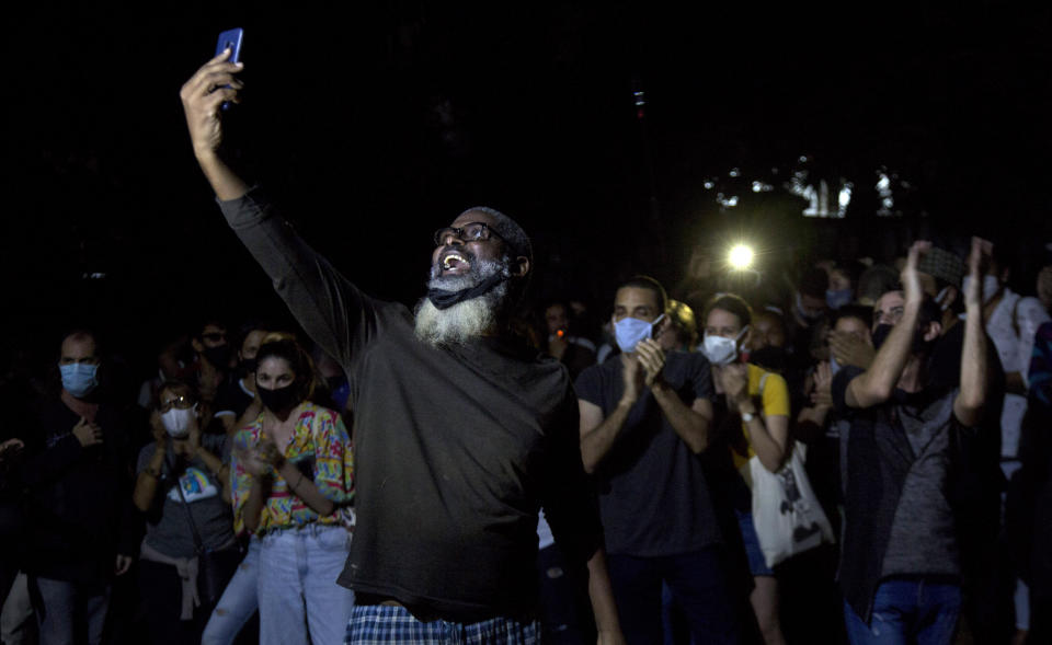 Young artists protest in front of the doors of the Ministry of Culture, in Havana, Cuba, Friday, Nov. 27, 2020. Dozens of Cuban artists demonstrated against the police evicting a group who participated in a hunger strike. (AP Photo/Ismael Francisco)