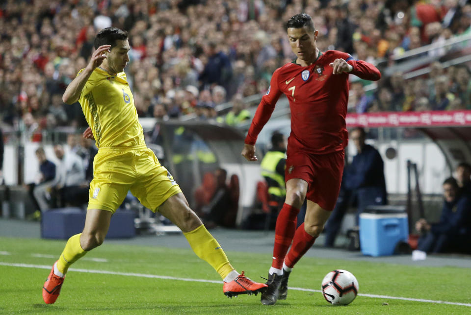 Portugal's Cristiano Ronaldo, right, dribbles past Ukraine's Taras Stepanenko during the Euro 2020 group B qualifying soccer match between Portugal and Ukraine at the Luz stadium in Lisbon, Friday, March 22, 2019. (AP Photo/Armando Franca)