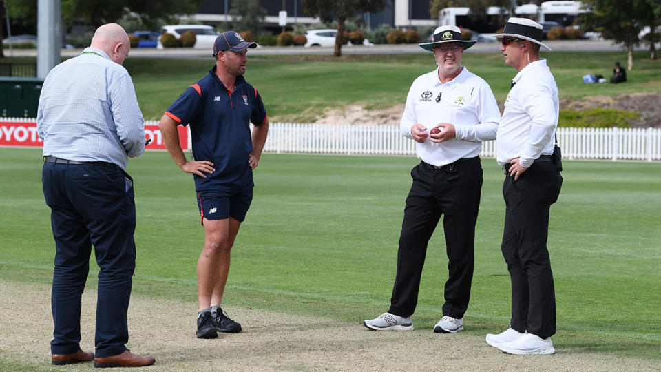 Match official Steve Davis and umpires Mike Graham-Smith and Donovan Koch, pictured here speaking with SACA grounds manager Trent Kelly.