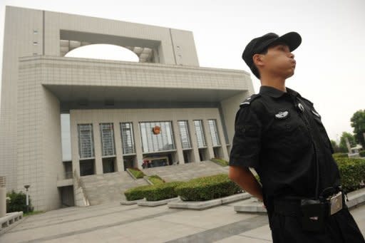 Police stand guard outside the Intermediate People's Court in Hefei during the murder trial of Gu Kailai, wife of the disgraced leader Bo Xilai, in August 2012. Gu was convicted of Neil Heywood's murder and given a suspended death sentence